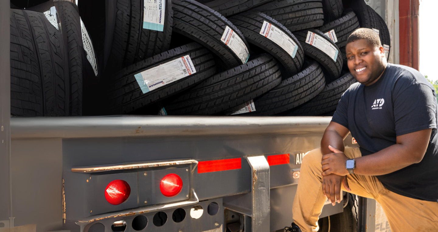 ATD Associate on the back of the truck full of tires