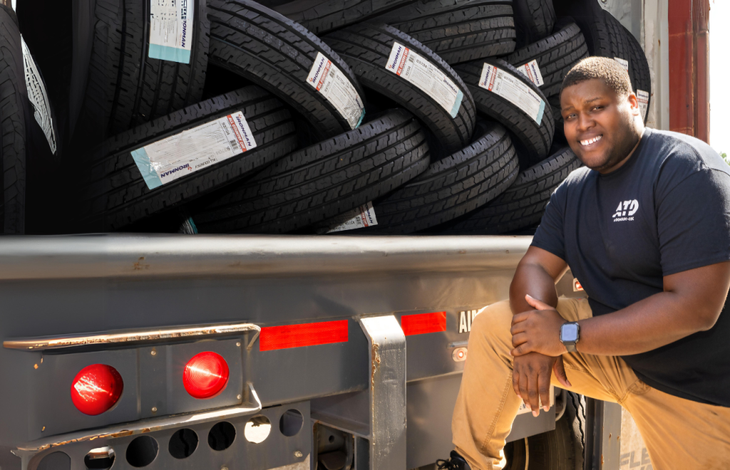 ATD Associate on the back of the truck full of tires