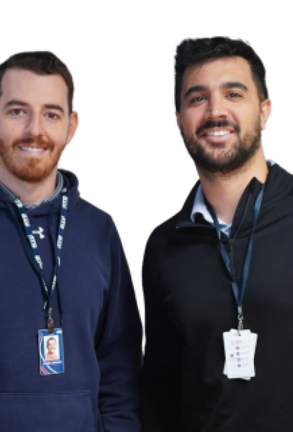 two associates smiling at the camera