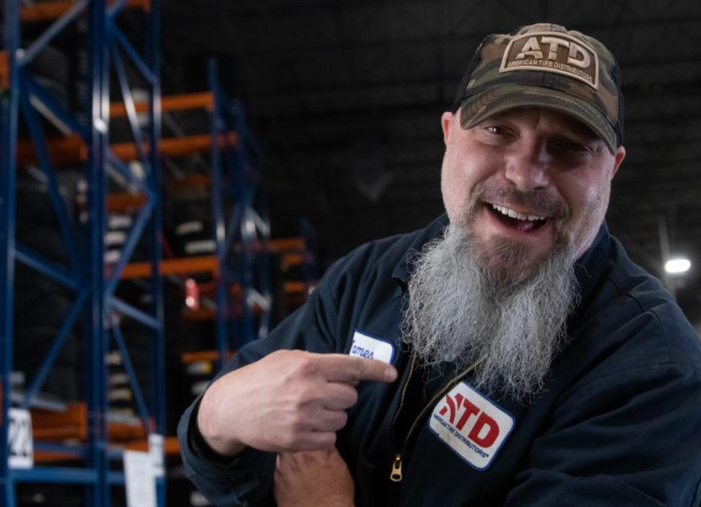 Male associate smiling with a long white/grey beard