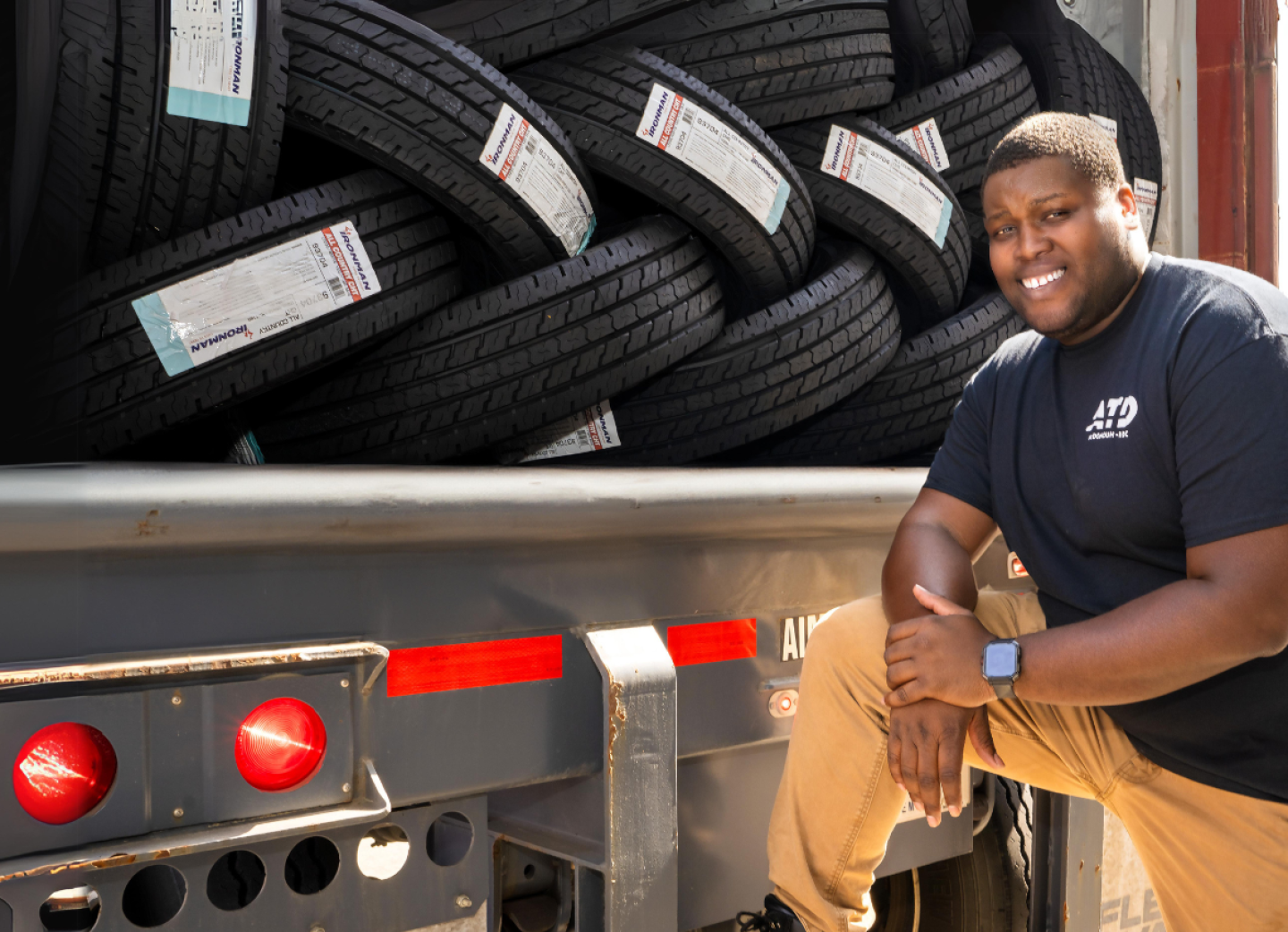 ATD Associate on the back of the truck full of tires